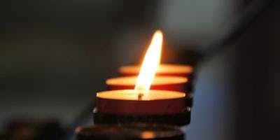 A lighted candle in honor of pets.